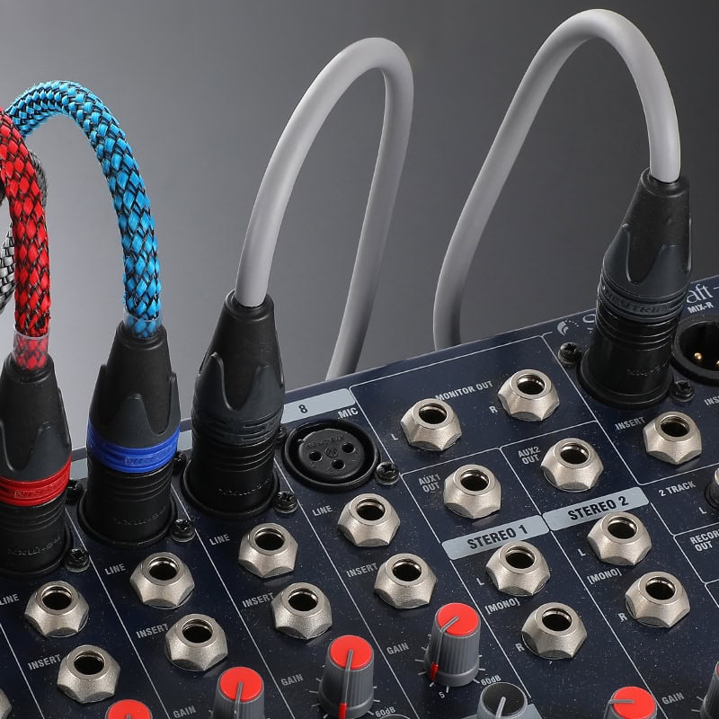 Audio cables plugged into audio devices